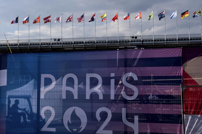 A worker drives a golf cart inside the competition venue for BMX freestyle ahead of the 2024 Summer Olympics, Friday, July 19, 2024, in Paris. (AP Photo/David Goldman)