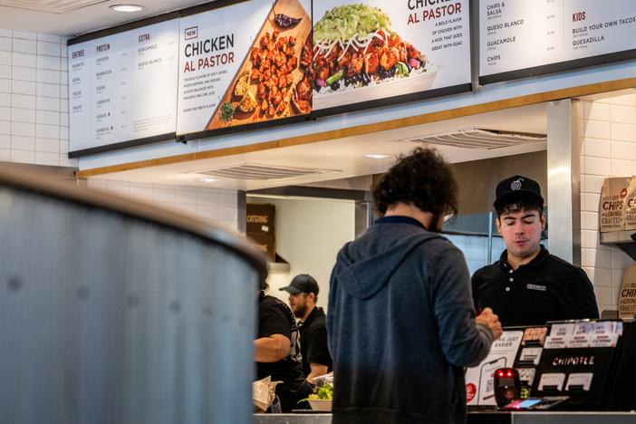 A customer pays for their food at a Chipotle Mexican Grill restaurant in Austin, Texas. Chipotle says its portion sizes have not shrunk, despite complaints shared on social media. 