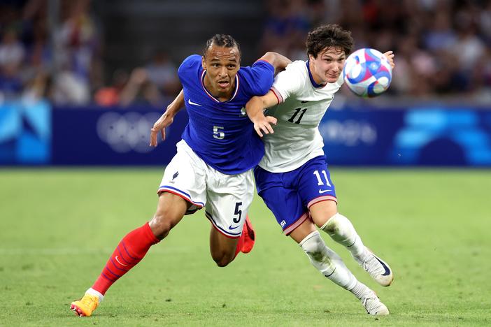 France's Kiliann Sildillia (left) is challenged by the USA's Paxten Aaronson in the opening game of group play at the 2024 Summer Olympics on Wednesday in Marseille, France.