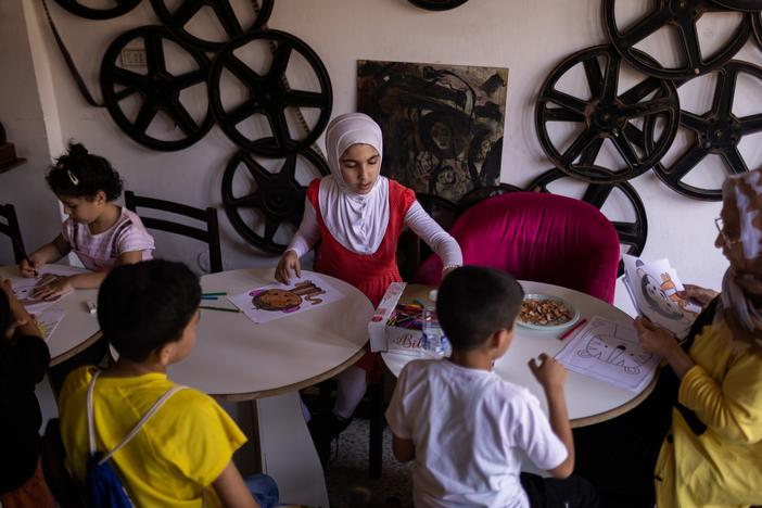 Sara Miliji, 12, from the border village of Naqoura, participates in an art class at a renovated movie theatre in the city of Tyre. Sara's family fled when their village was bombed. They now live along with hundreds of other families in a schoolroom turned into a shelter.<br>