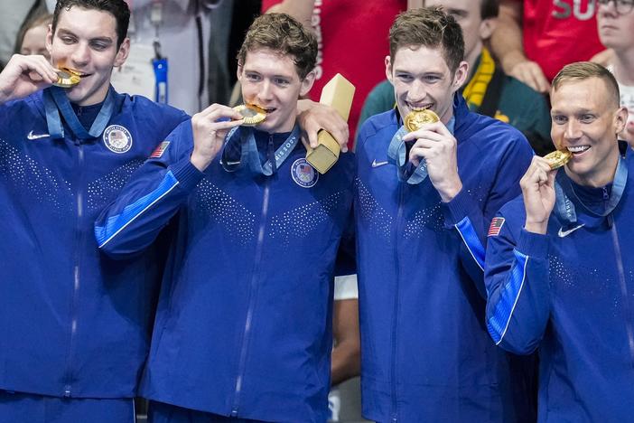 Team USA's men's swimming team stands on the podium after winning gold in the men's 400-meter freestyle relay final at the Paris Olympics on Saturday.