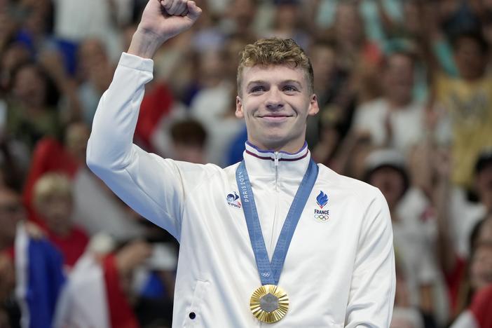 Leon Marchand, of France, celebrates after receiving his first gold medal in the men's 400-meter individual medley final at the 2024 Paris Summer Olympics on Sunday in Nanterre, France.