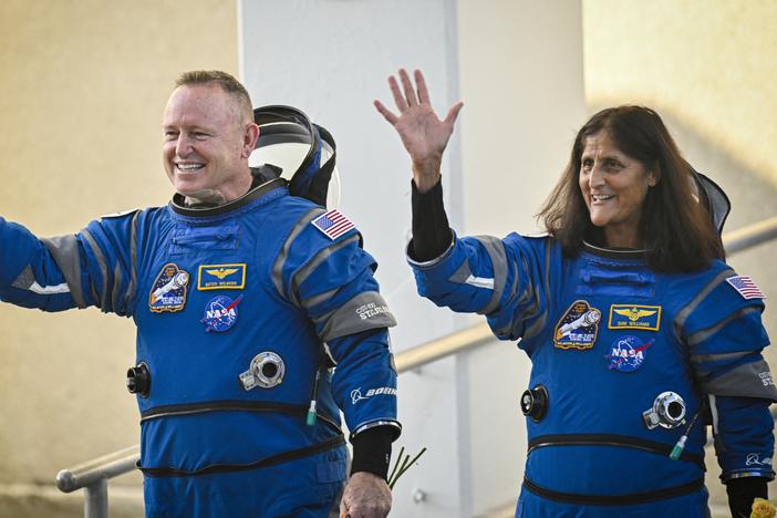 NASA astronauts Butch Wilmore and Suni Williams wave as they prepare to depart the Neil A. Armstrong Operations and Checkout Building at Cape Canaveral Space Force Station in Florida to board the Boeing CST-100 Starliner spacecraft on June 5.