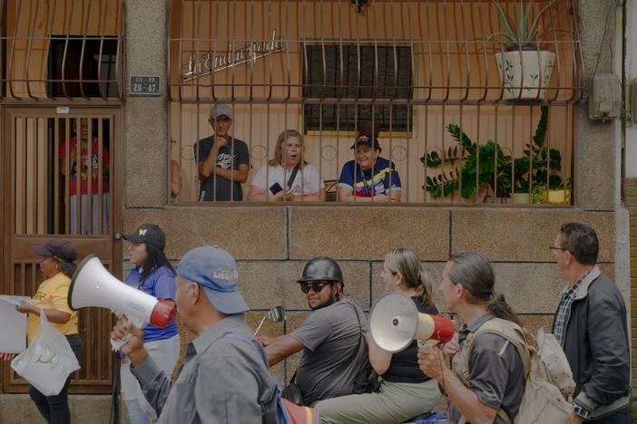 Residents and community organizers take the street in the La Vega neighborhood of Caracas, Venezuela, on Wednesday morning to show support for opposition candidate Edmundo Gónzalez, going door to door to explain the ballot.