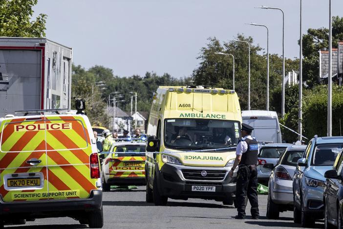 Emergency services work at the scene in Southport, England, where a man has been detained and a knife has been seized after a number of people were injured in a reported stabbing on Monday.