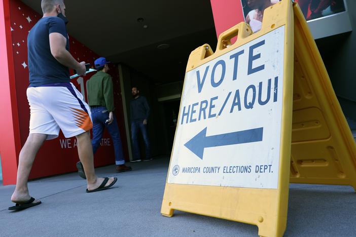 Voters head to a polling place in November 2022. Outside money is pouring into a Phoenix-area congressional district in a heated Democratic primary on Tuesday.