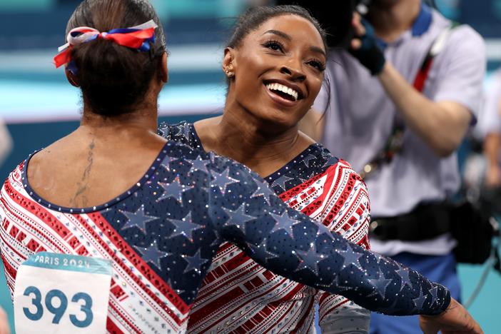 Simone Biles was all smiles with teammate Jordan Chiles after finishing her routine on the uneven bars during the women's gymnastics team final at the Olympic Games in Paris. 
