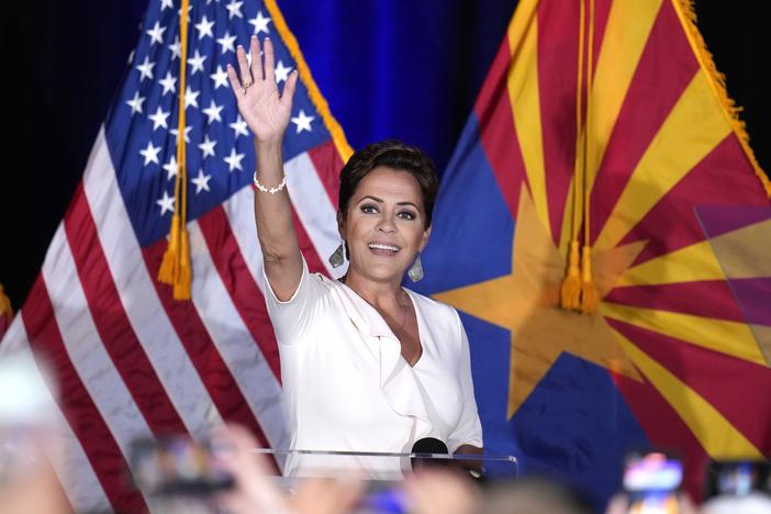 Republican Arizona Senate candidate Kari Lake waves to supporters as she arrives on stage after being declared her party's primary winner on Tuesday in Phoenix. 