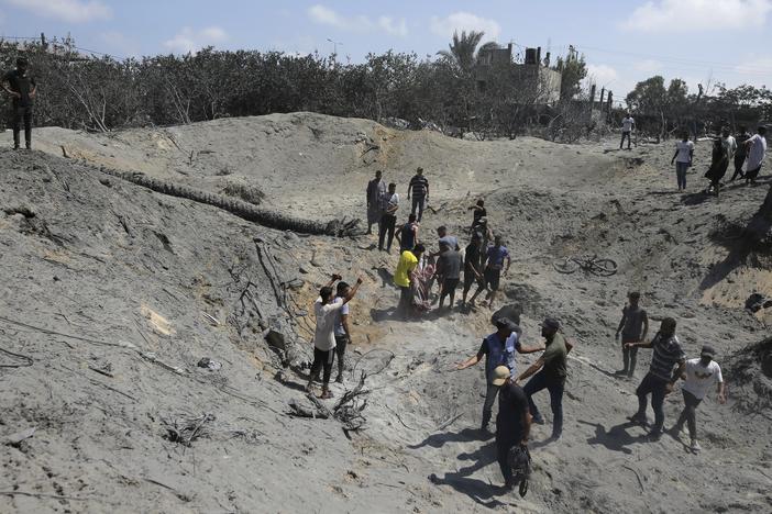 Palestinians search for bodies and survivors in a site hit by an Israeli bombardment on Khan Younis, southern Gaza Strip, on July 13 in which the Israeli military claim they killed the head of Hamas' military wing, Mohammed Deif.