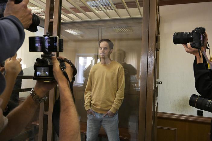 <em>Wall Street Journal</em> reporter Evan Gershkovich stands in the glass defendant's booth at the Moscow City Court, in Moscow on Sept. 19, 2023. 