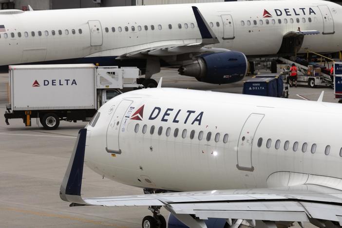 The Biden administration has proposed a rule to ban additional fees for seating family members together on planes. Here, a Delta Air Lines plane leaves the gate on July 12, 2021, at Logan International Airport in Boston.