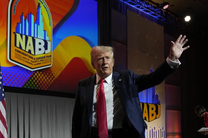 Former President Donald Trump walks off stage after speaking at the National Association of Black Journalists convention in Chicago on Wednesday.