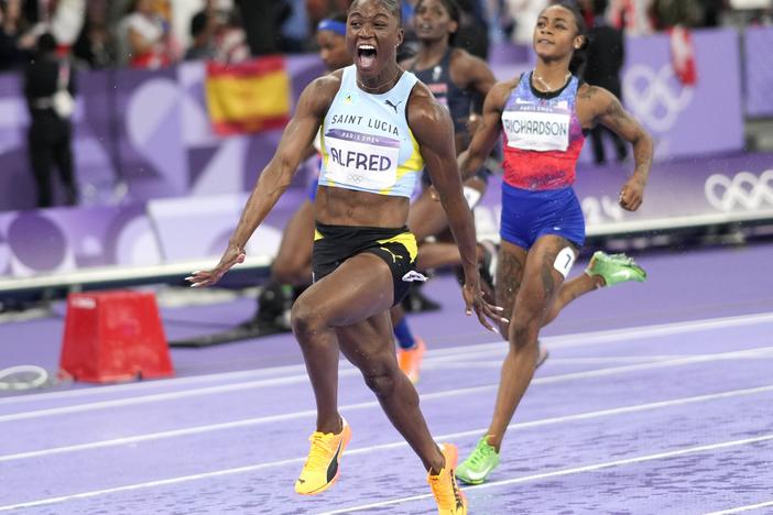 Julien Alfred, of Saint Lucia, celebrates after winning the women's 100-meters final at the 2024 Summer Olympics, Saturday, Aug. 3, 2024, in Saint-Denis, France. (AP Photo/Bernat Armangue)