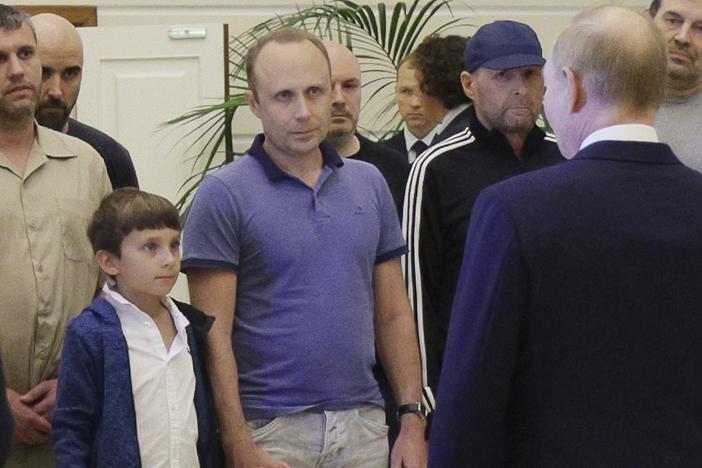 A man identified as Pablo González, second from left with shaved head, listens to Russian President Vladimir Putin, speaking to released Russian prisoners upon their arrival at the Vnukovo government airport outside Moscow, Russia, on Thursday, Aug. 1, 2024.