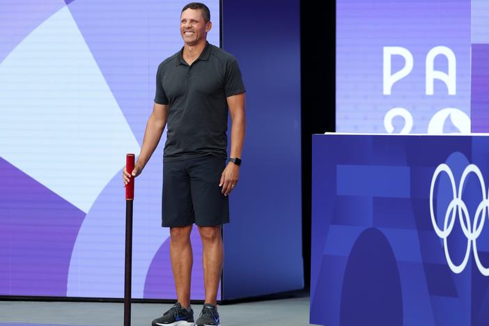 Dan O'Brien, a former American decathlete, bears the brigadier ahead of the High Jump portion of the Decathlon at Stade de France on Friday. He's about to command the attention of the stadium's raucous crowd as part of a new, very French Olympic custom.