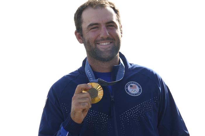 Gold medalist Scottie Scheffler, of the United States, poses with his medal following the medal ceremony for men's golf during the medal ceremony at the 2024 Summer Olympics on Sunday, Aug. 4.
