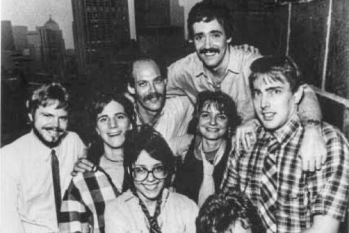 Scott Simon (top right) and Ina Jaffe (center left) pose for a picture with other NPR Chicago Bureau staff. 