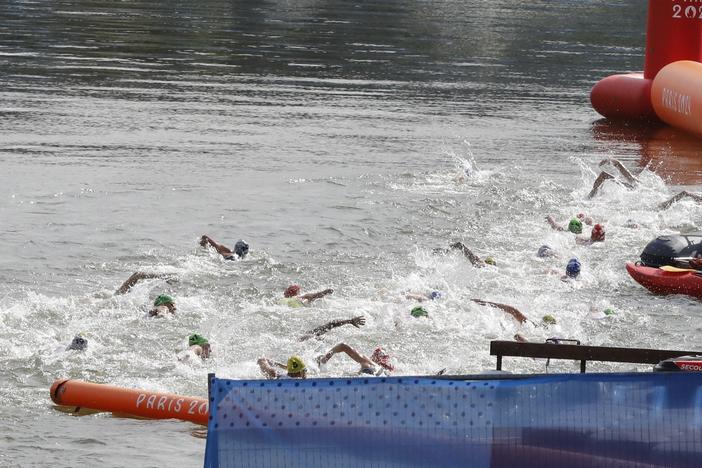 Athletes swim in the Seine river for the triathlon event at the Olympic Games in Paris on Wednesday, July 31. 