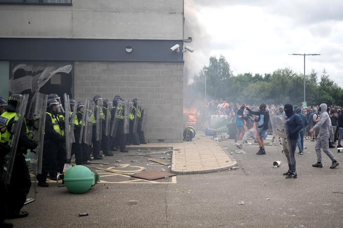 Riot police clashed with anti-immigration protesters outside of a Holiday Inn Express, which is used to house asylum seekers, in Rotherham, United Kingdom, on Sunday.