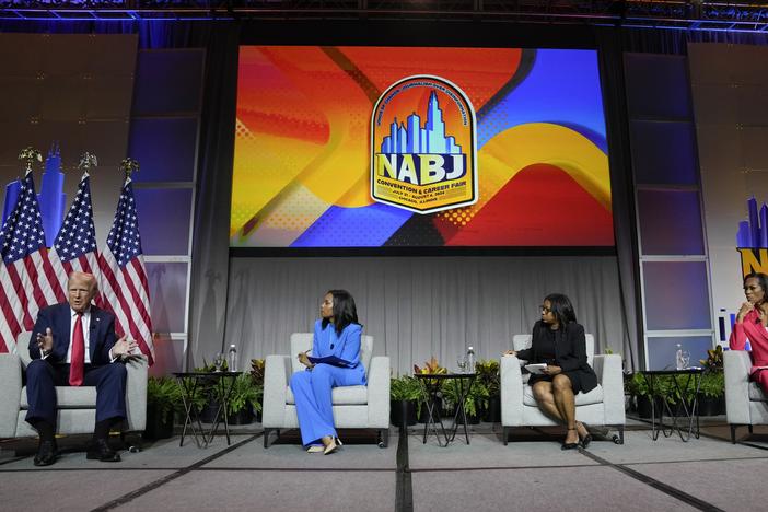 Former President Donald Trump appears on a panel at NABJ on Wednesday in Chicago. From left, ABC's Rachel Scott, Semafor's Kadia Goba and FOX News' Harris Faulkner moderated the event.
