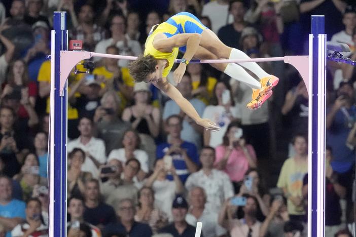 Armand Duplantis, of Sweden, clears the bar at 6.25m to set a new world record during the men's pole vault final at the 2024 Summer Olympics on Monday in Saint-Denis, France.