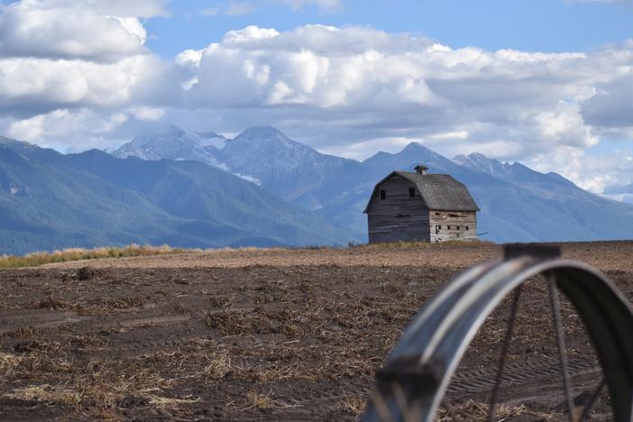 A barn near Pablo, Montana with the Mission Mountains in the distance. Western Montana is experiencing more frequent heat waves, and officials are concerned about health impacts on isolated rural residents.