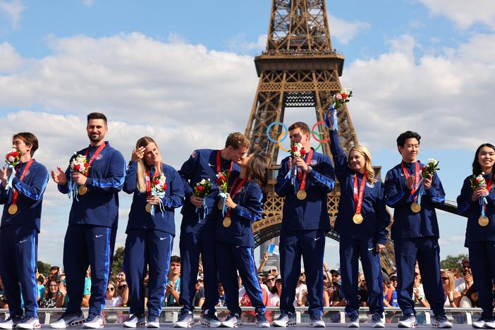 Two years after they won, members of the U.S. figure skating team celebrate their victory and receive their gold medals won during the 2022 Beijing Winter Olympics. The delayed ceremony, held during the Paris Summer Games, follows the recent disqualification of Russia following a doping controversy.