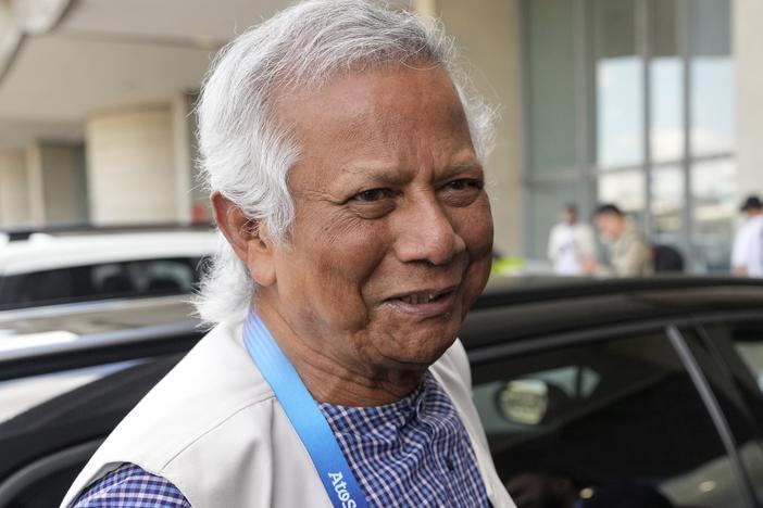 Nobel laureate Muhammad Yunus smiles upon his arrival at Charles de Gaulle's airport in Roissy, north of Paris, on Wednesday. 