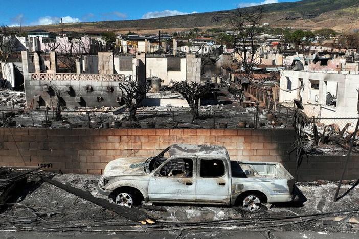  In an aerial view, burned cars and homes are seen a neighborhood that was destroyed by a wildfire on August 17, 2023 in Lahaina, Hawaii. 