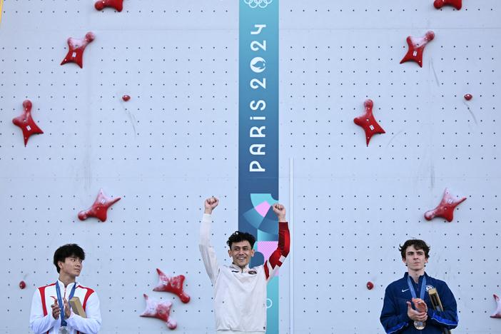 Gold medalist Indonesia's Veddriq Leonardo (center), silver medallst China's Wu Peng (left) and bronze medalist UsA's Sam Watson (right) pose on the podium of the men's sport climbing speed event during the Paris Olympics at the Le Bourget Sport Climbing Venue northeast of Paris.
