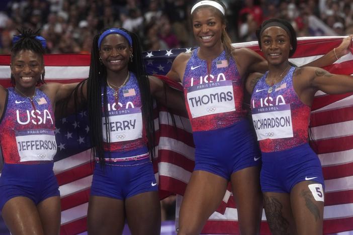 United States women's 4x100-meter relay final team pose for a photo after winning the gold medal at the 2024 Summer Olympics on Friday in Saint-Denis, France.