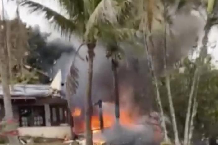 This frame grab from a video shows fire coming from a plane that crashed by a home in Vinhedo, Sao Paulo state, Brazil, Friday.