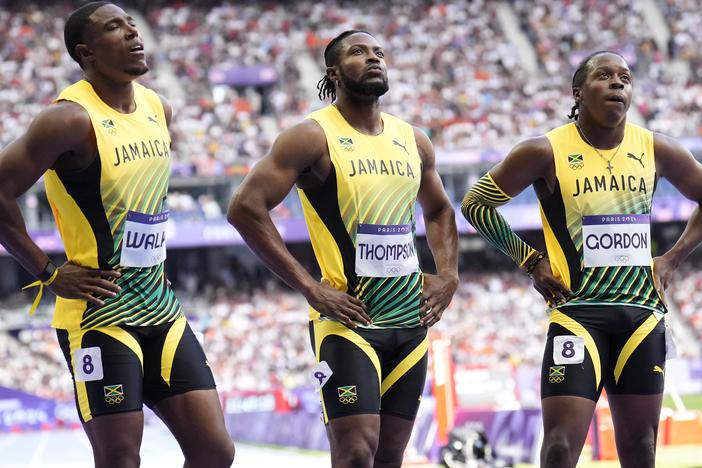 Members of Jamaica's men's 4x100-meter relay team react following their heat at the Paris Olympics on Thursday, in Saint-Denis, France.