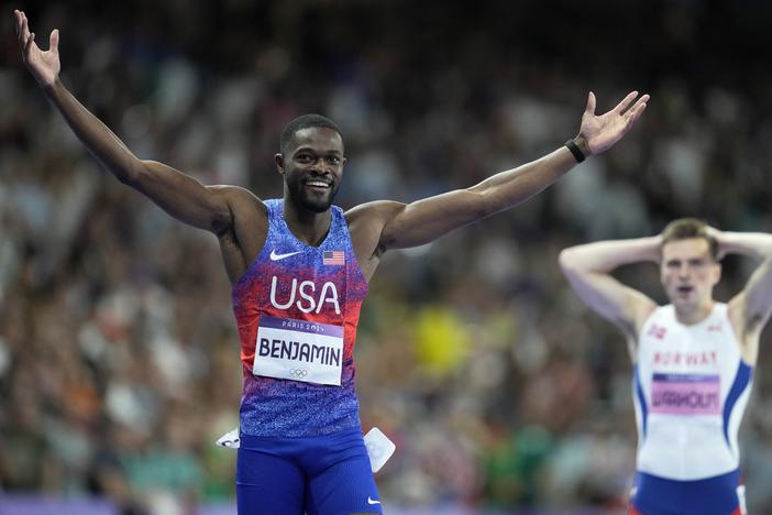 Rai Benjamin of the U.S. celebrates after winning gold ahead of silver medalist Karsten Warholm of Norway, seen behind him, in the 400-meter hurdles final at the Paris Olympics on Friday.