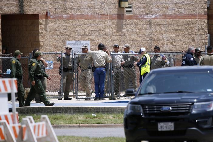 Law enforcement and other first responders gather outside Robb Elementary School following a shooting, Tuesday, May 24, 2022, in Uvalde, Texas. 
