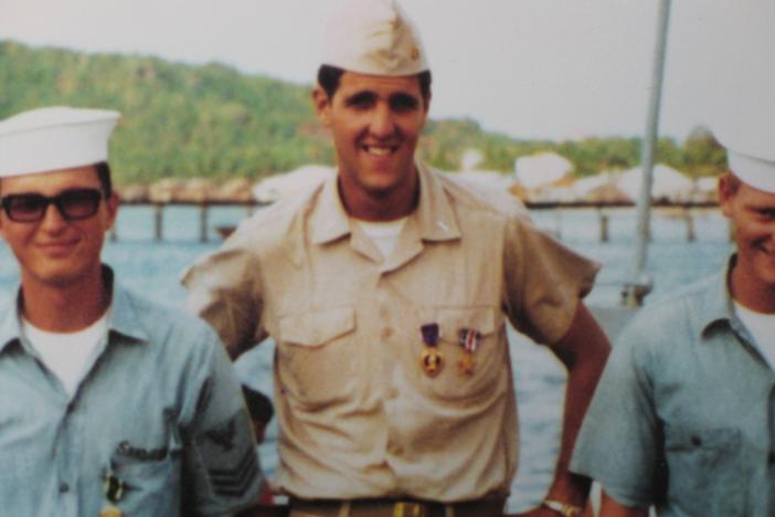 John Kerry (center) stands with other military personnel in an unspecified location circa the 1960s. The details of Kerry's service during the Vietnam War, and his subsequent anti-war activism, became the focus of a veterans' group's smear campaign against him during his 2004 presidential campaign.