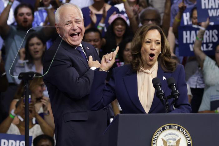 Vice President Harris (R), introduces Democratic vice presidential candidate Minnesota Gov. Tim Walz (L) during a campaign rally at Temple University on Monday in Philadelphia.