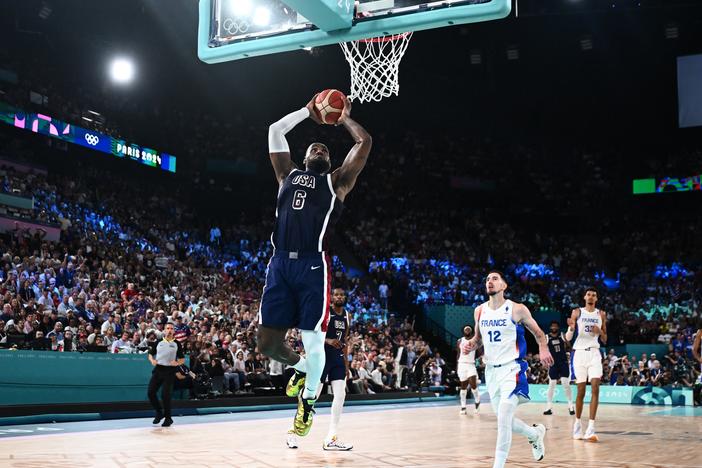LeBron James dunks the ball during the men's Gold Medal basketball match between France and USA at the Paris Olympics on Saturday. The U.S. downed France to win its fifth straight Olympic gold medal - extending a lengthy streak of international dominance.
