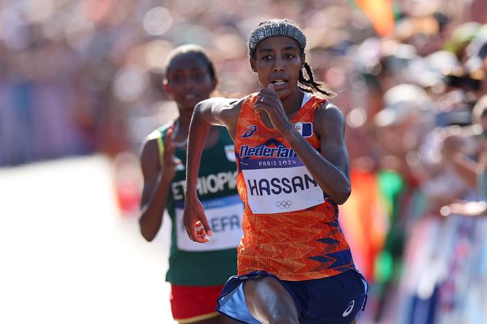 Sifan Hassan of the Netherlands stays ahead of Ethiopia's Tigst Assefa at the finish of the women's marathon on Sunday at the Paris Olympics. Hassan won gold, adding to two bronzes she won in the 5,000 and 10,000 meter races.
