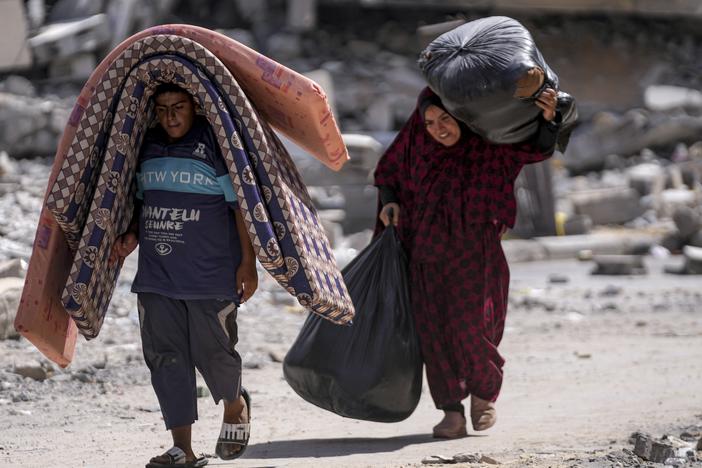 Palestinians displaced by the Israeli air and ground offensive on the Gaza Strip flee from Hamad City, following an evacuation order by the Israeli army to leave parts of the southern area of Khan Younis, Sunday. 
