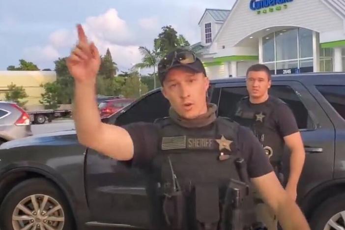  A sheriff's deputy in Florida warns a "First Amendment auditor" to back away in a screengrab from YouTube.