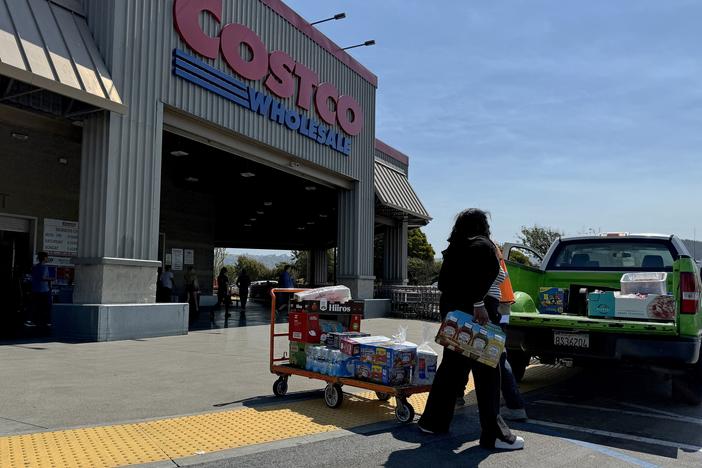 A customer loads a pickup truck after shopping at a Costco store on July 11 in Richmond, Calif.