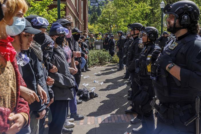 Pro-Palestinian students and activists face police officers after protesters were evicted from the library at Portland State University in Portland, Ore., in May.