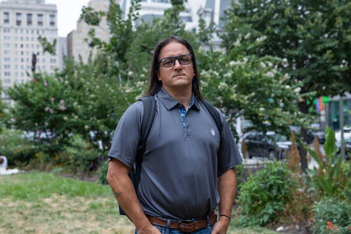 Andrew DiDonato, a construction plan review specialist with Philadelphia's Department of Licenses and Inspections, stands near City Hall on July 22, 2024. After four years of working a hybrid schedule, he's been called back into the office five days a week.