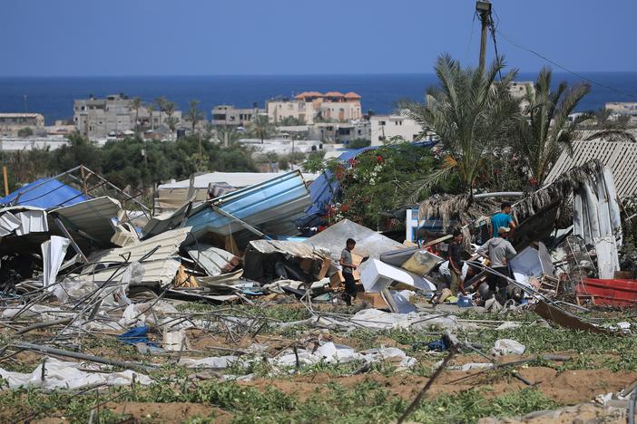 People look for salvageable items following an Israeli raid in Rafah's al-Mawasi area in the southern Gaza Strip, June 29.