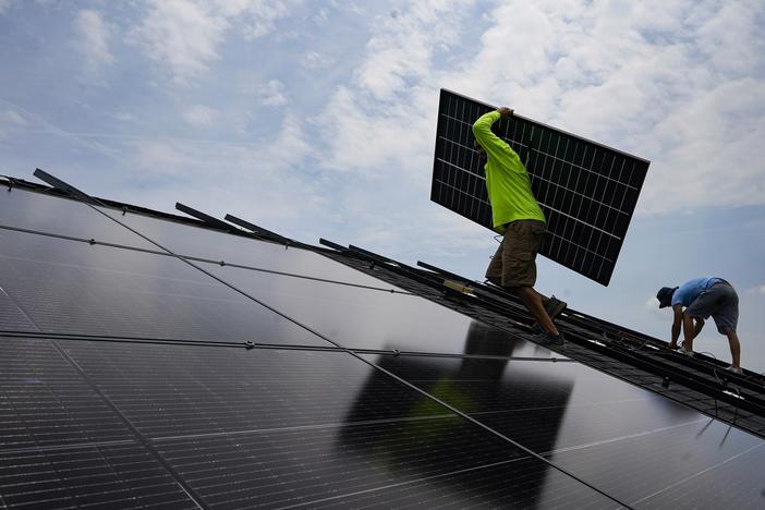 A crew installs a solar array on the roof of a home in Frankfort, Ky., in 2023. 