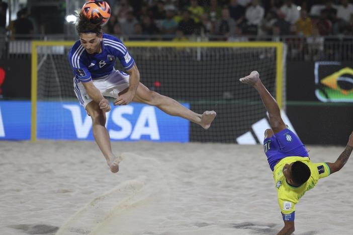Datinha of Brazil does a bicycle kick Feb. 25 as Italy's Tommaso Fazzini defends during the FIFA Beach Soccer World Cup final between Brazil and Italy at the Dubai Design District Stadium in Dubai, United Arab Emirates.