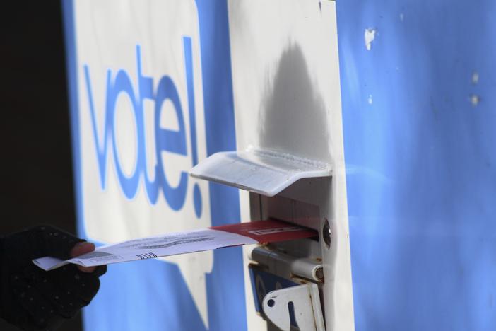 In this file photo, a person drops off a ballot at a drop box during the presidential primary election on Tuesday, March 12 in Seattle. Washington state is reliably Democratic in its voting, but its late summer top-two primary has predictive power for how the nation feels about the two main political parties.