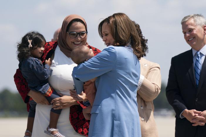 Vice President Harris holds the baby of Durham County Board of Commissioners chair Nida Allam upon arrival at Raleigh-Durham International Airport in North Carolina on Aug. 16, 2024.