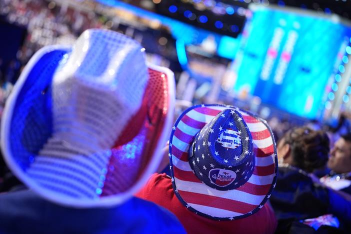 Attendees wear American flag themed hats during the first day of the Democratic National Convention in Chicago, Illinois.